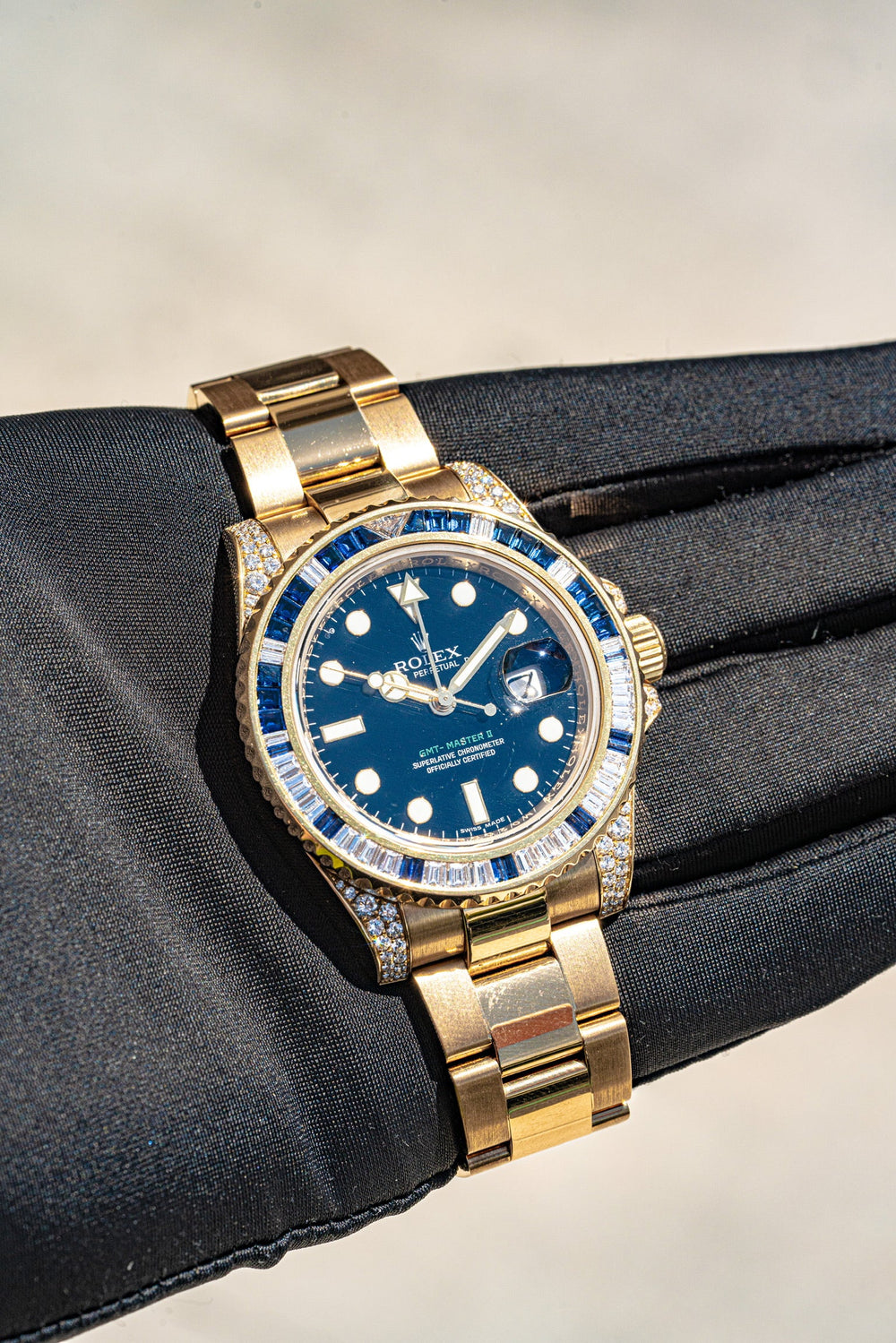 Rolex GMT Master displayed on a gloved hand