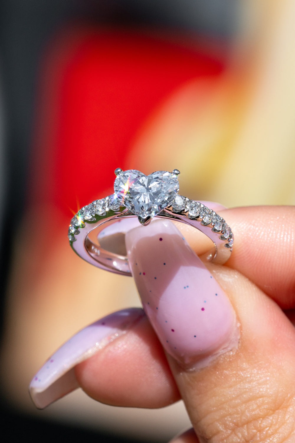 Heart shaped diamond ring held in hand