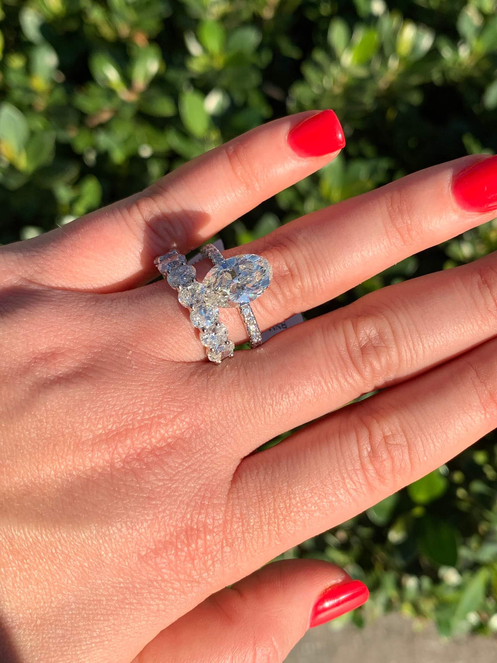 Oval diamond engagement ring and band worn together