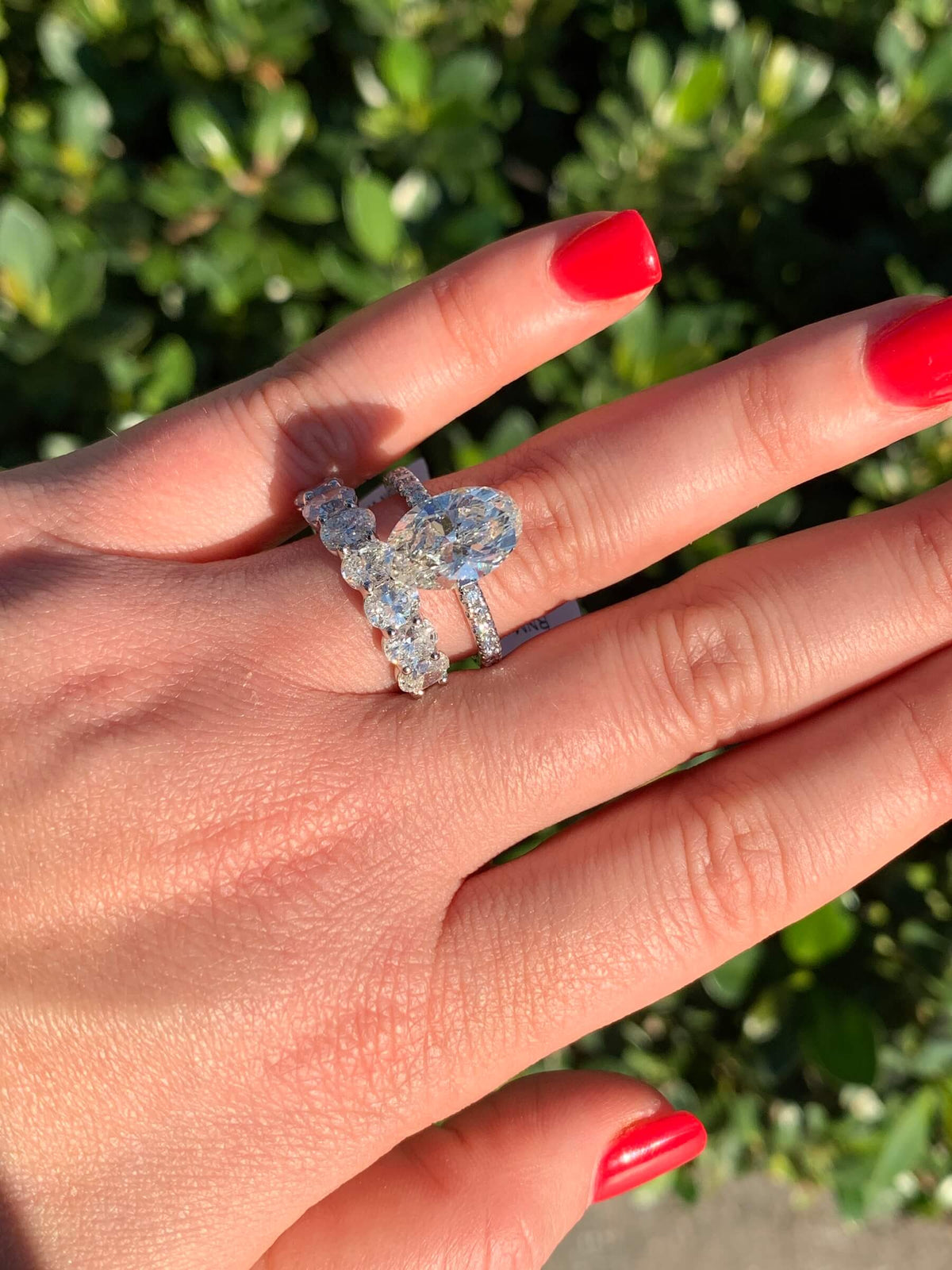 Oval diamond engagement ring and band worn together