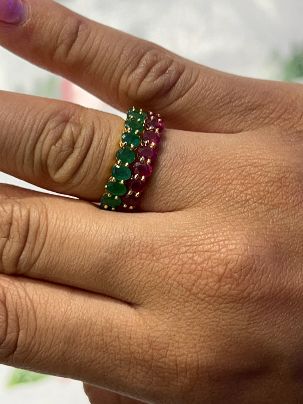 Ruby and emerald bands worn together