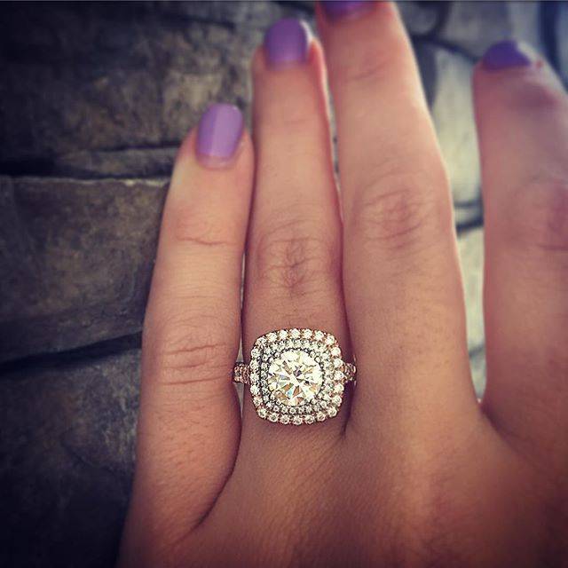 A cushion shaped double halo engagement ring with a round diamond? Perfection.