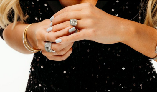 Woman wearing a diamond engagement ring and matching wedding band on her hand