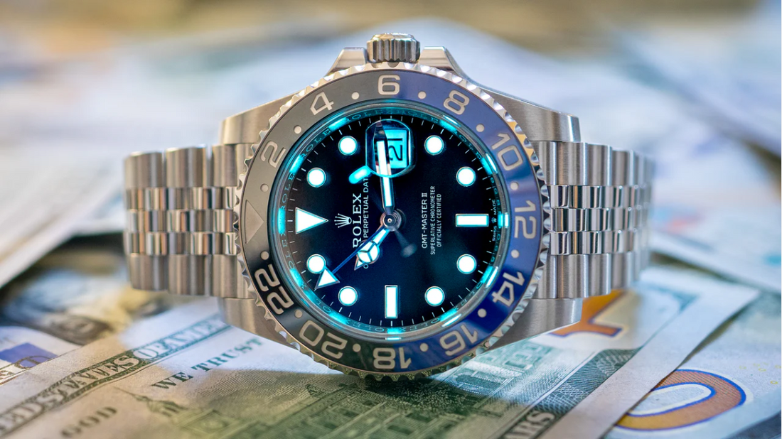 Rolex GMT-Master II luxury watch on cash, symbolizing selling luxury watches in Boca Raton for top dollar.