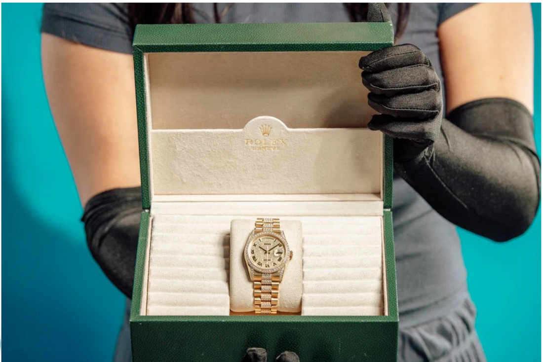 Luxury Rolex watch displayed in original green box with warranty packaging and gold bracelet, presented for authentication and premium timepiece sale.