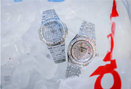 Diamond-encrusted Patek Philippe luxury watches with iced dials and bracelet bands displayed on ice