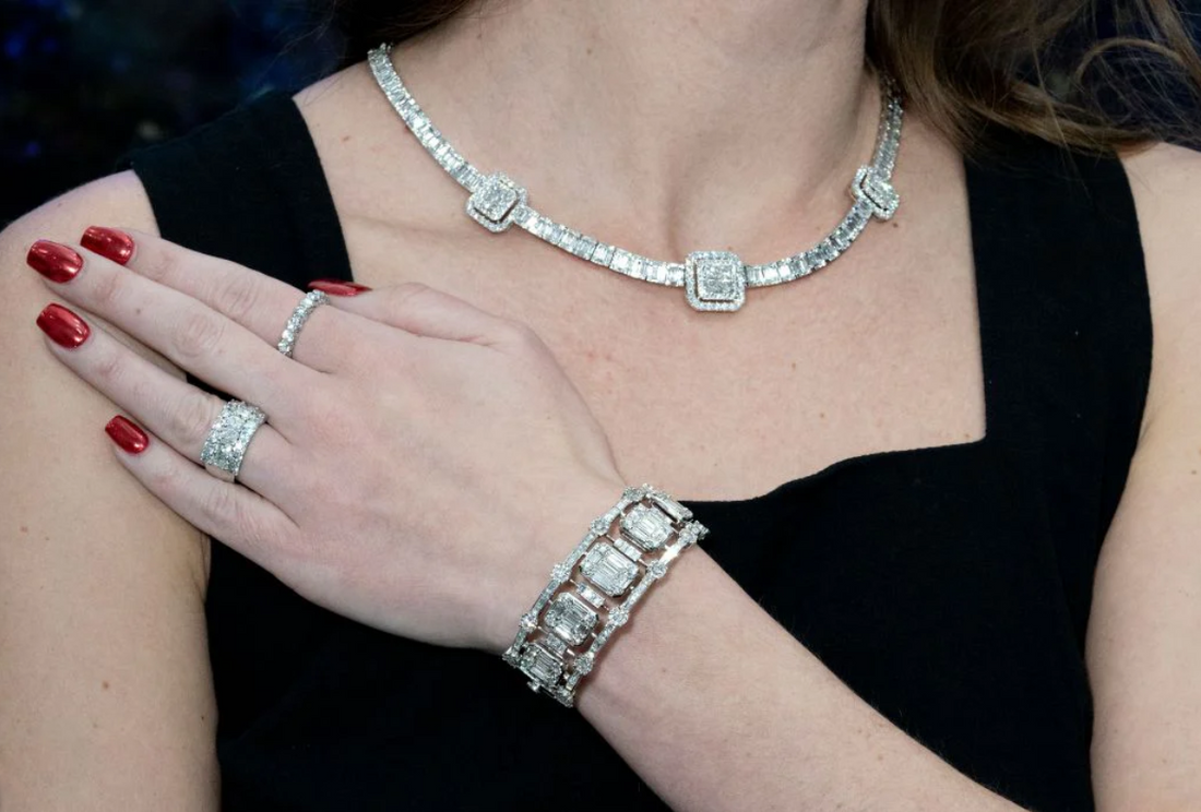 Woman wearing luxury diamond jewelry including a diamond necklace, bracelet, and rings, showcasing high-end fine jewelry craftsmanship and elegance.