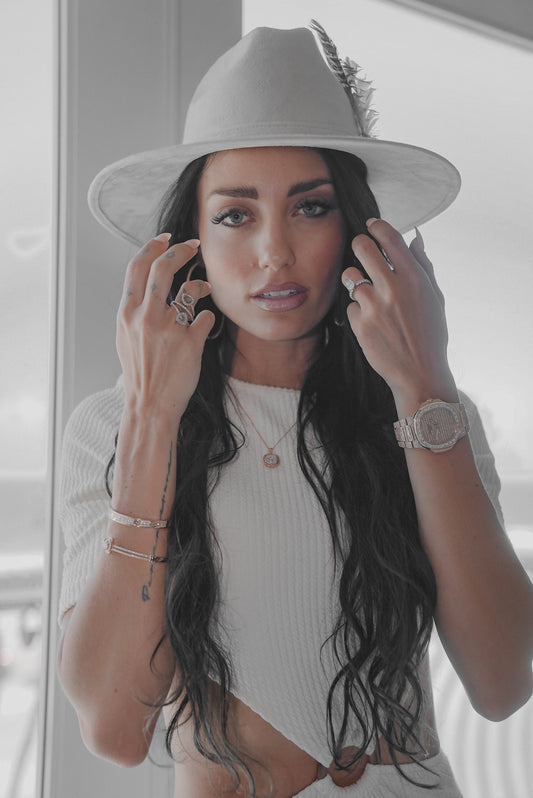 Lady in white wearing a Gorgeous halo rose gold silver pendant