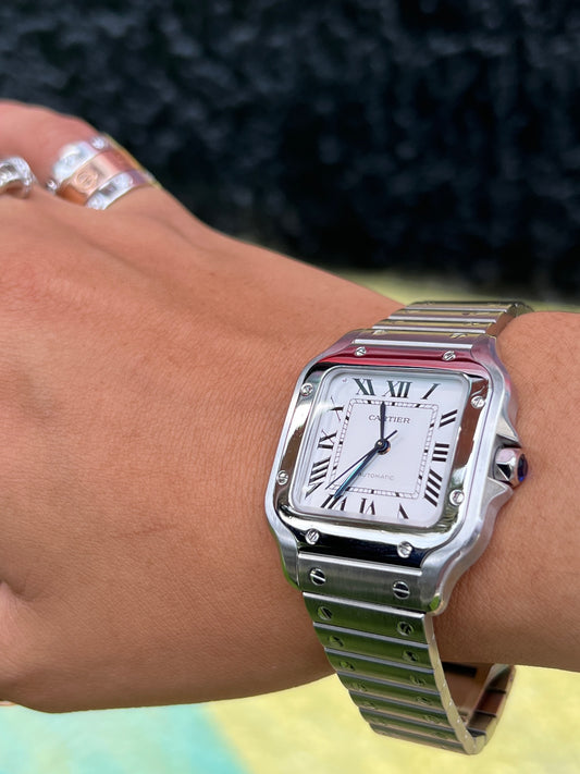 a Santos De Cartier watch on the wrist