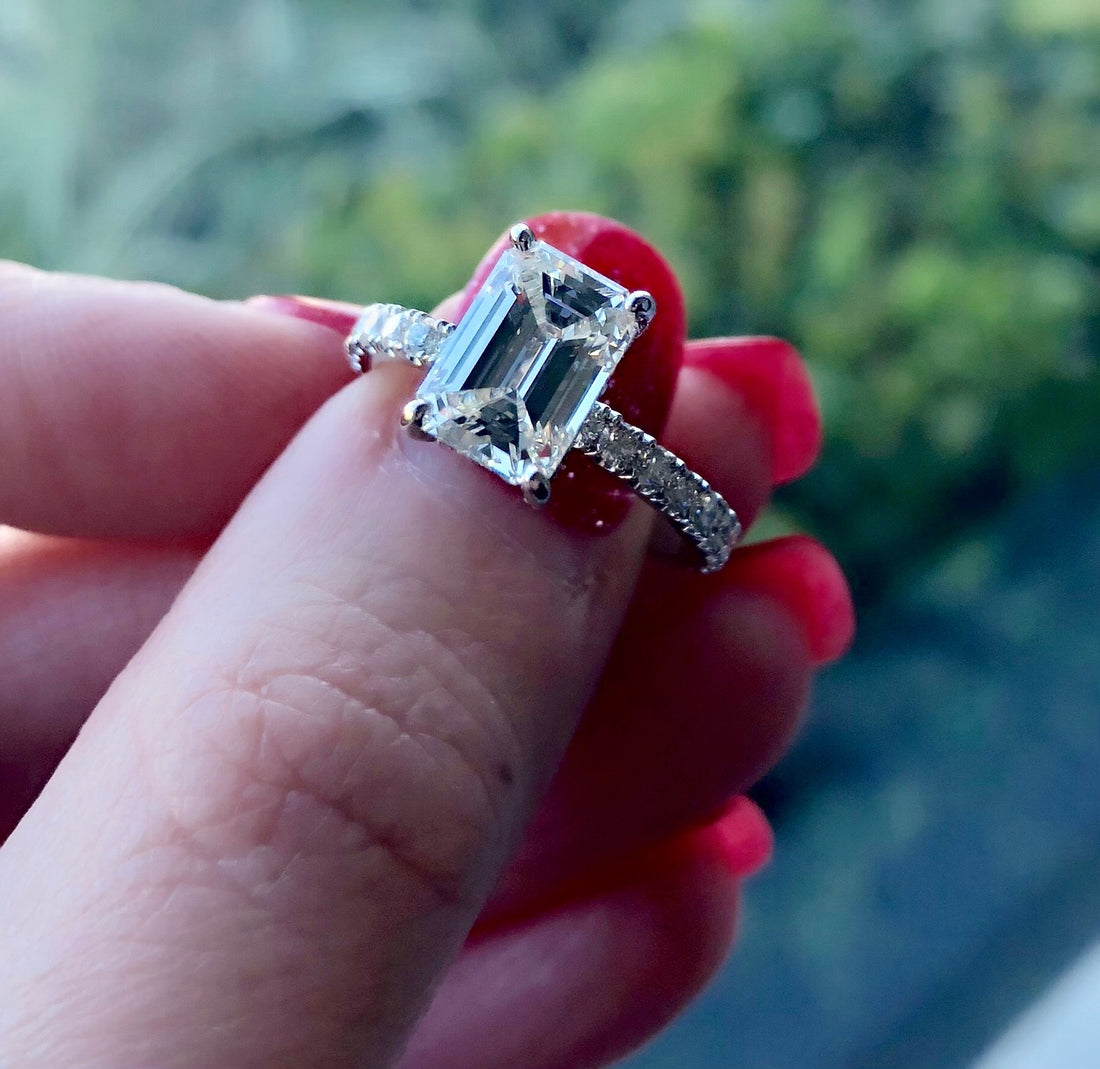 emerald cut engagement ring with accent diamond band