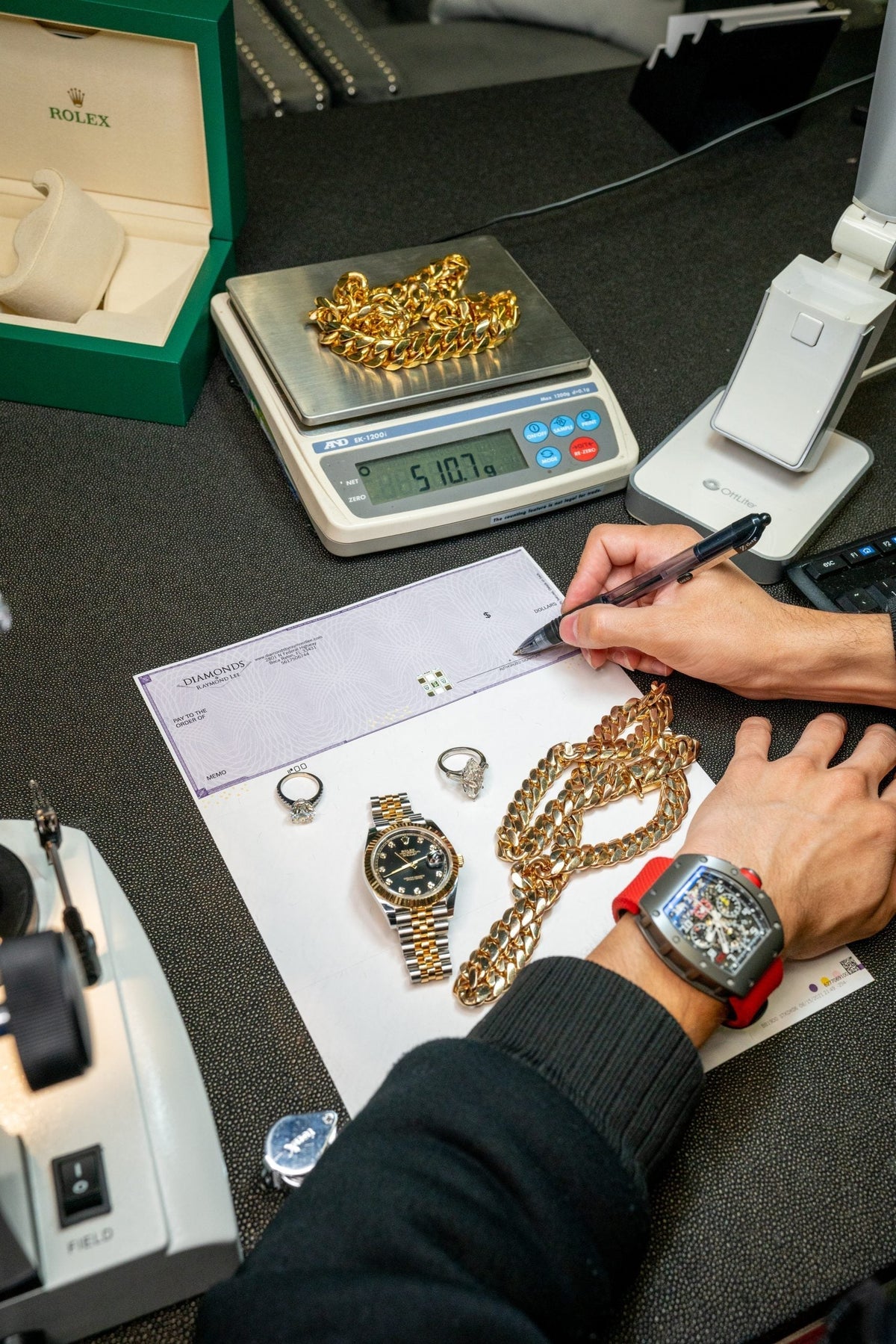 Jewelry being documented and weighed for a collateral evaluation