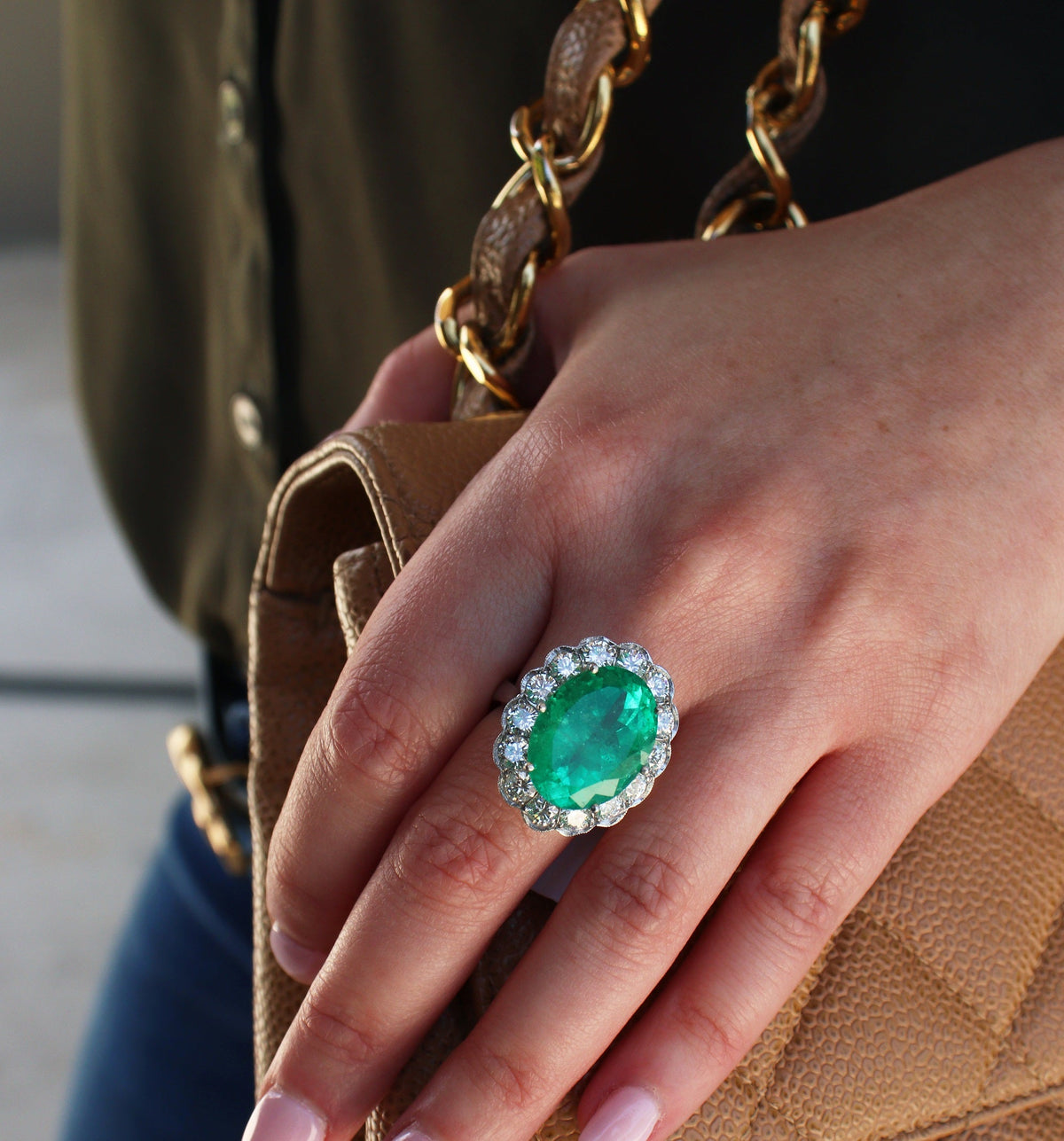 Emerald ring worn with a handbag