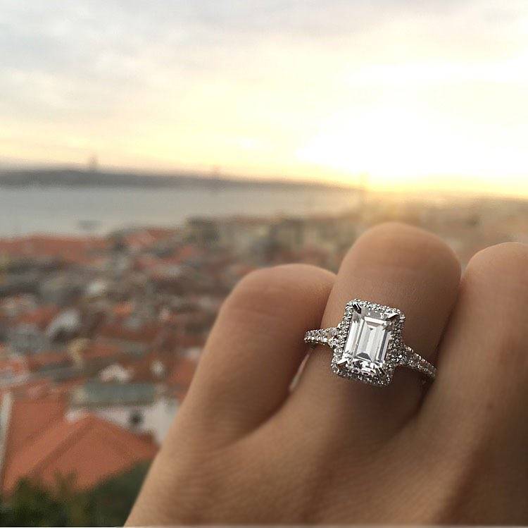 An engagement ring showcased behind a scenic background.