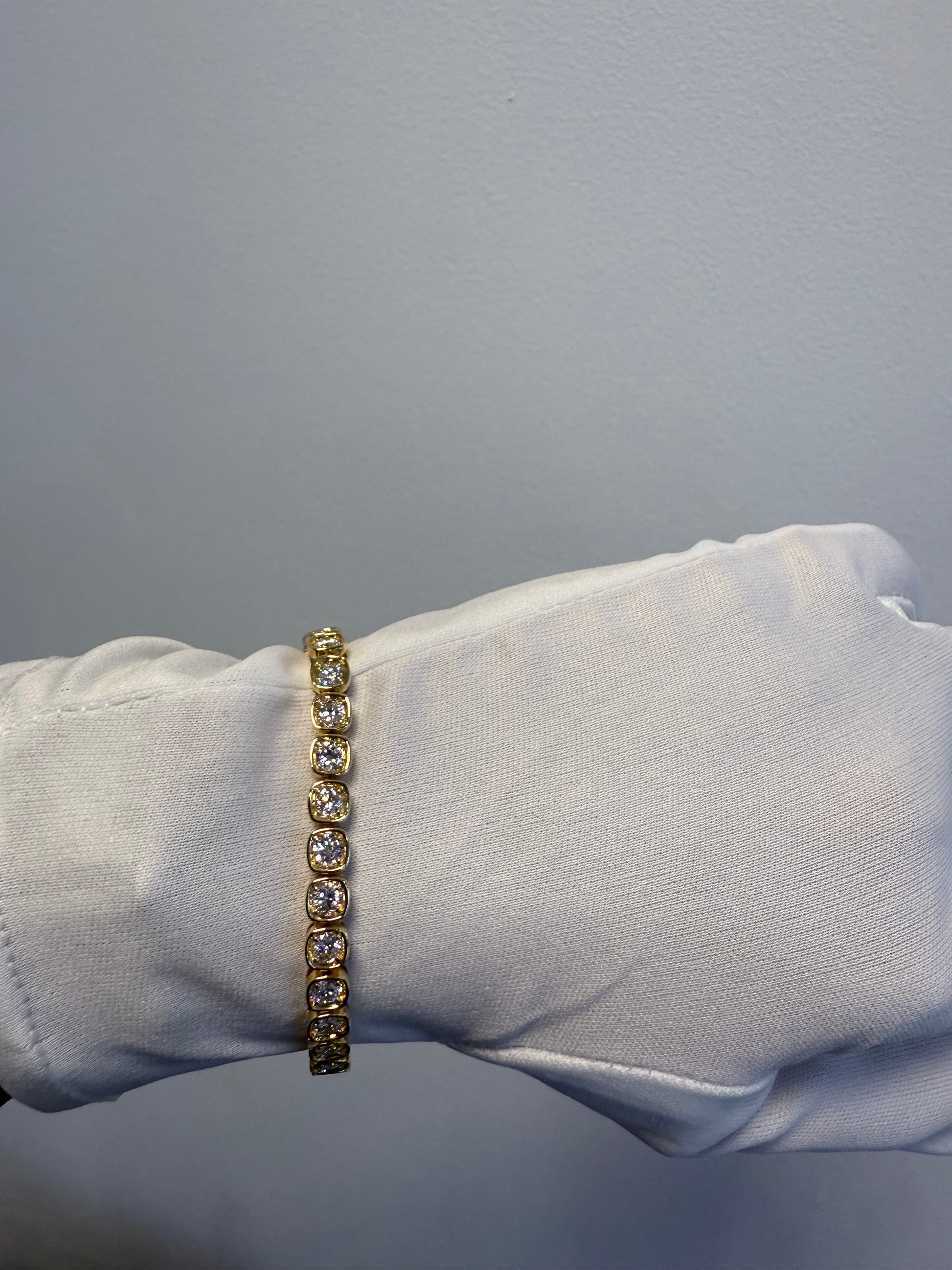 18K Yellow Gold Natural 6.60 Carats Round Brilliant Cut Tennis Bracelet in a Square Bezel Set