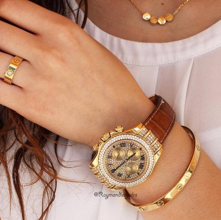 Gold bracelet, necklace and diamond-set watch worn together
