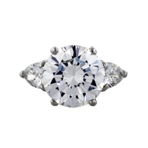 Round brilliant diamond engagement ring with pear shaped side stones