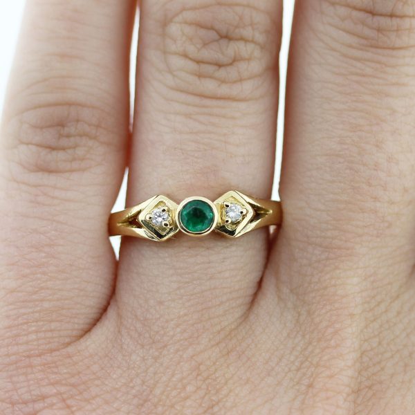 18kt Yellow Gold Emerald & Diamond Ring on finger
