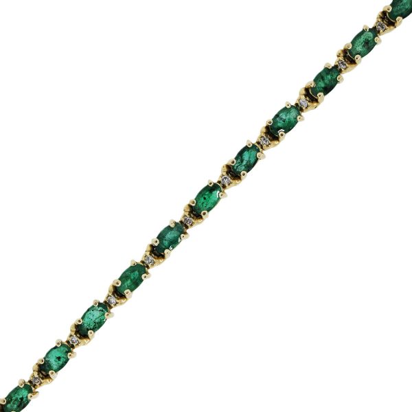 You are viewing this yellow gold diamond and emerald tennis bracelet!