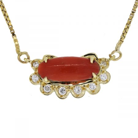 We love this 18kt Yellow Gold Cabochon Coral and Diamond Necklace