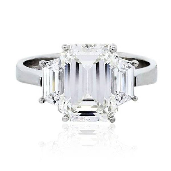 Emerald cut three stone engagement ring
