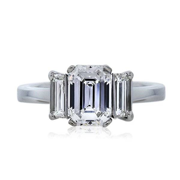 Three stone emerald cut engagement ring