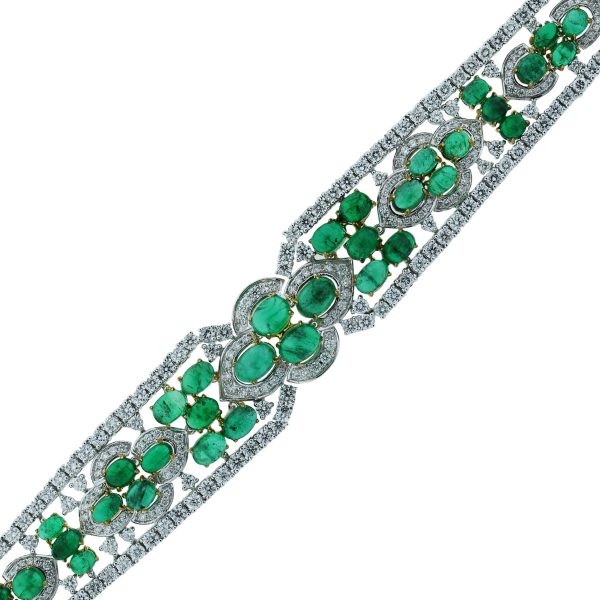 You are viewing this 18k Two Tone 32.25ctw of Diamonds and Emeralds Bracelet!