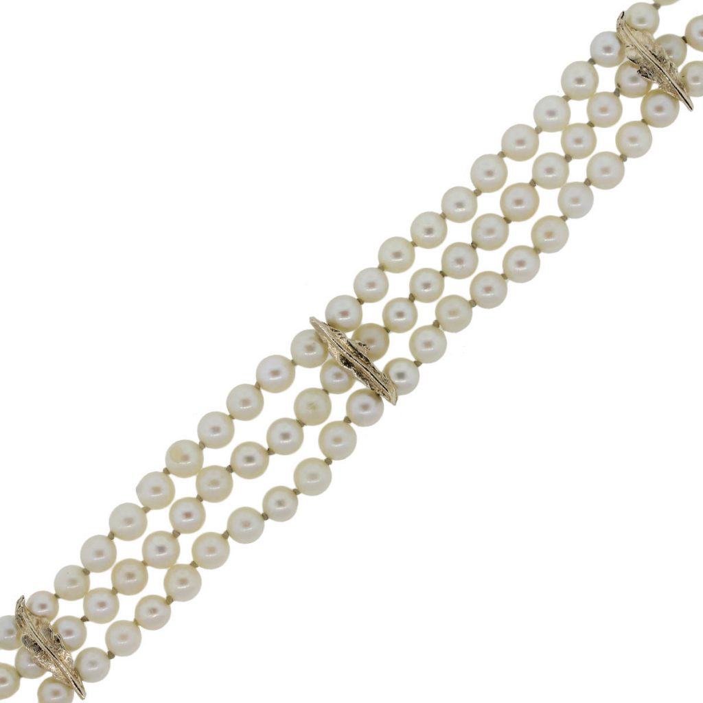 You are viewing this 14k Yellow Gold Triple Strand Pearl Flower Bracelet!