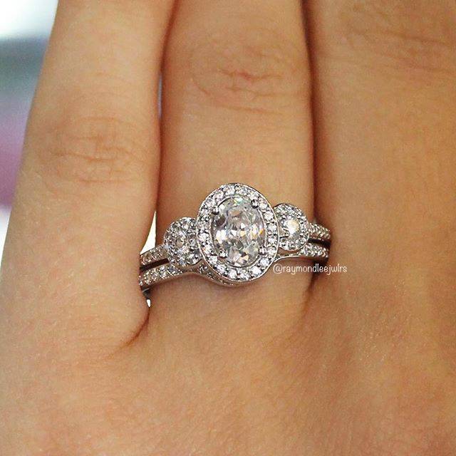 Three stone oval halo engagement ring