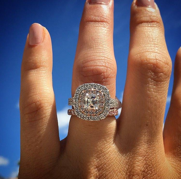 Rose gold halo engagement ring with cushion cut diamond