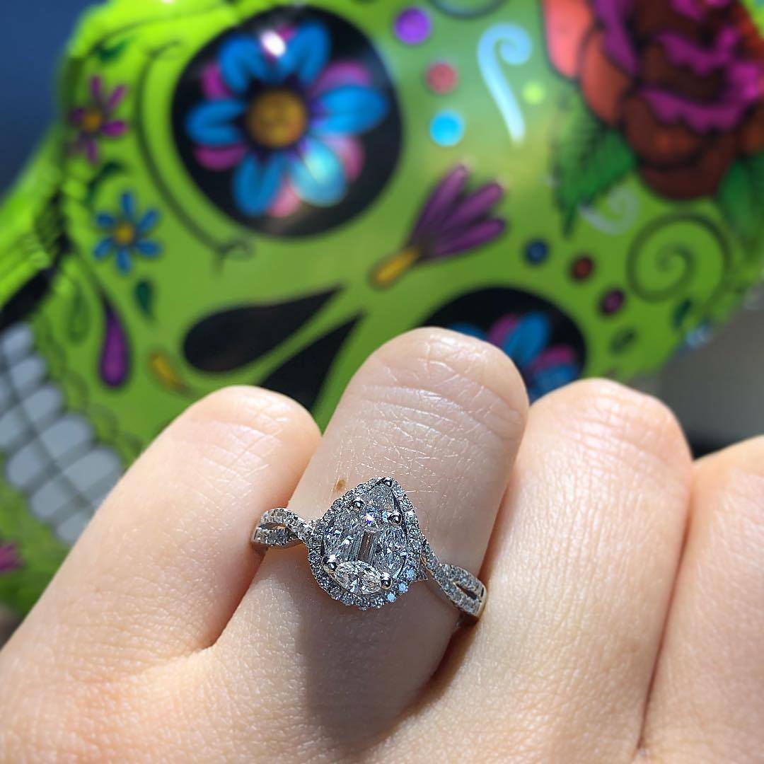 An engagement ring with a funky colored style of colors.