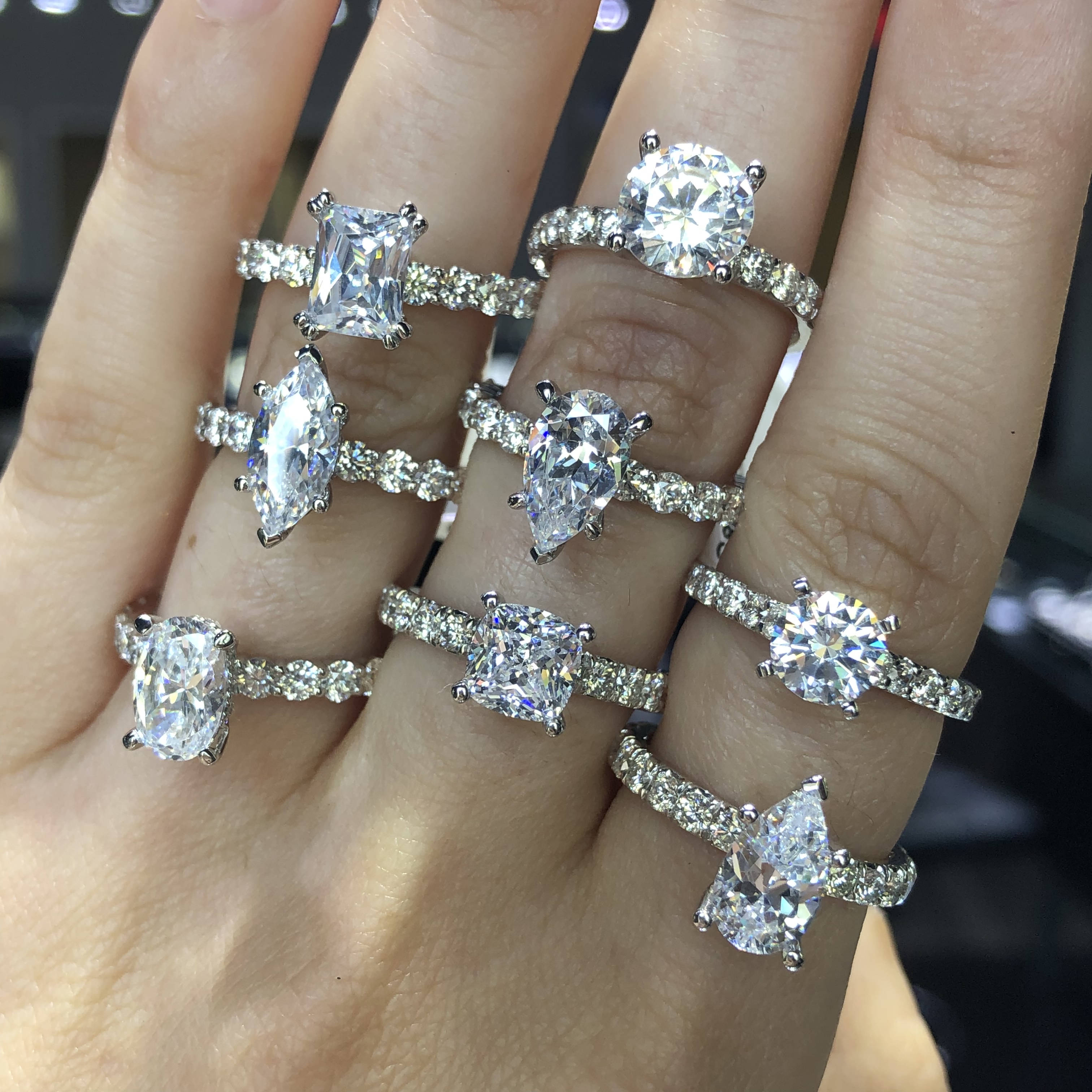 how much to spend on an engagement ring look at several rings with diamond bands