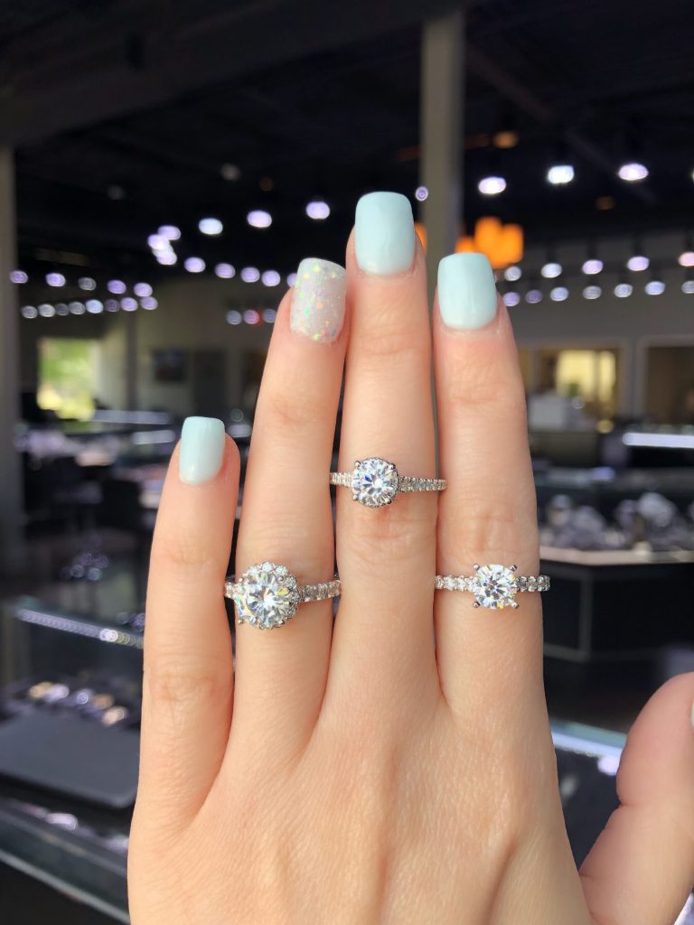 three diamond engagement rings at showroom