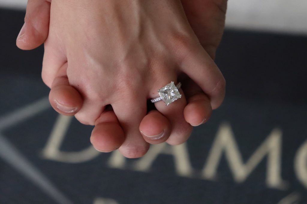 custom engagement ring on finger