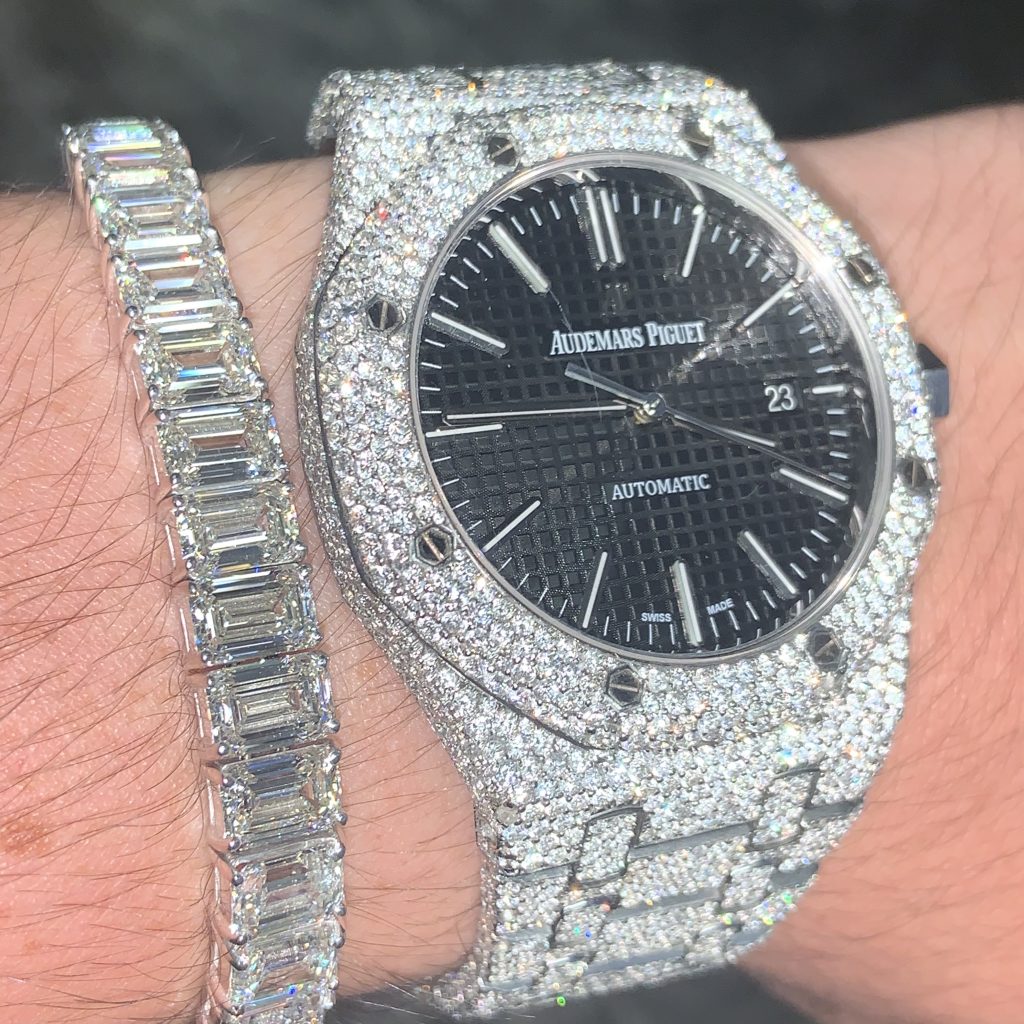 emerald cut diamond tennis bracelet and iced out audemars piguet watch black dial