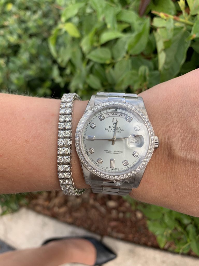 rolex oyster perpetual with diamond bezel worn with diamond tennis bracelet