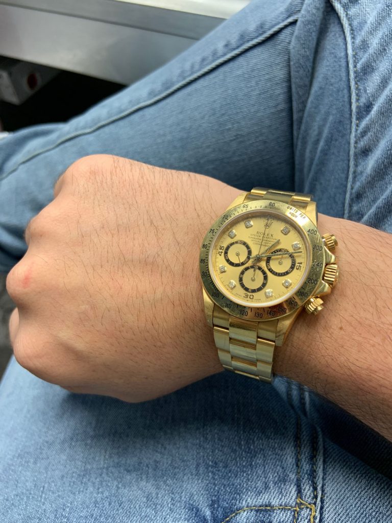 rolex daytona gold on wrist