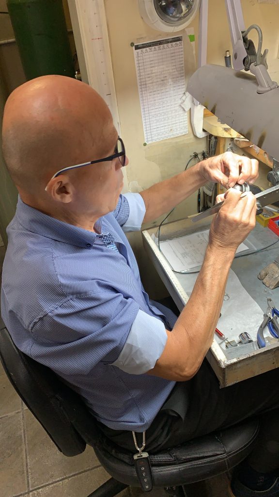 craftsman working on jewelry repair and custom jewelry creation