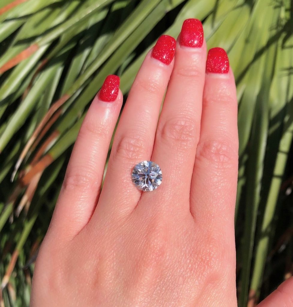 diamond balanced on hand at jewelry store that buys jewelry 
