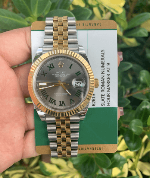 rolex watches for men held up with card