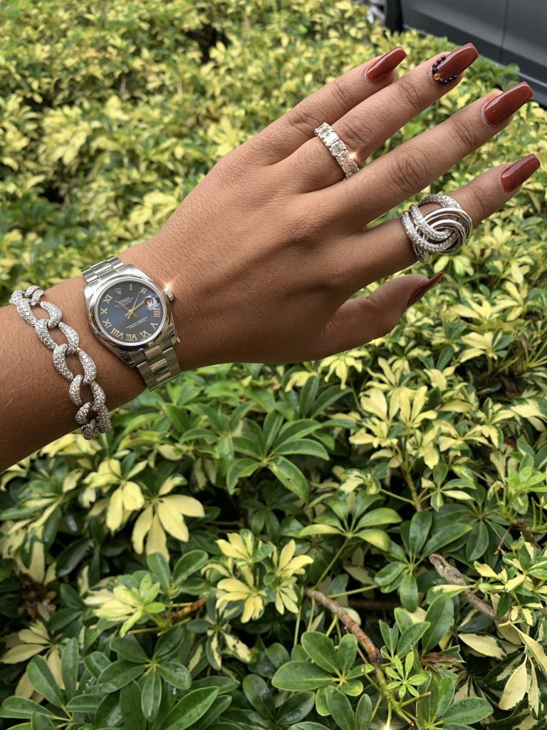 rolex watch and designer jewelry worn together