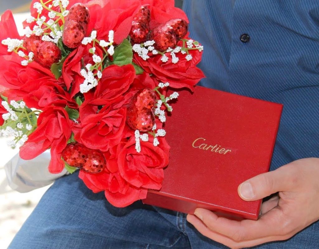 cartier love bracelet inside box with red flowers