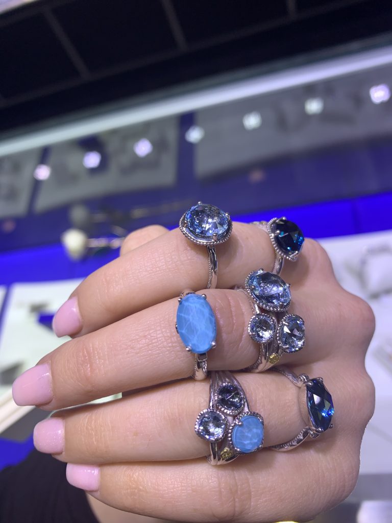 many blue gemstone rings worn together for ring appraisal in jewelry appraisal