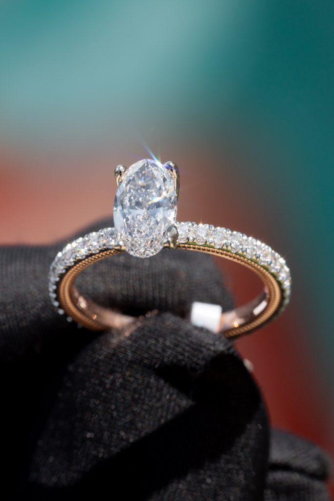 an oval diamond in a pave-set ring