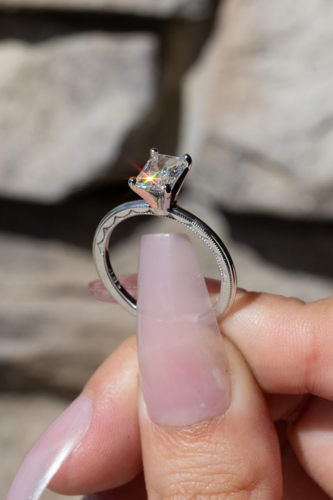 a solitaire ring with a radiant-cut diamond 