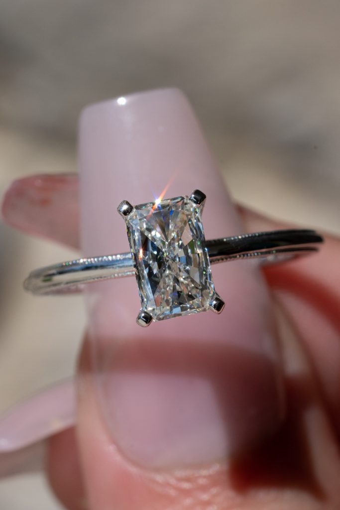 a radiant-cut diamond in a solitaire ring